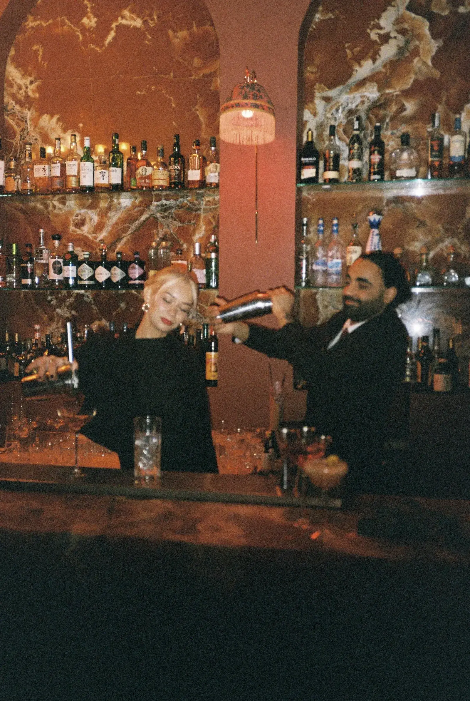Bartenders mixing cocktails behind the Patara bar